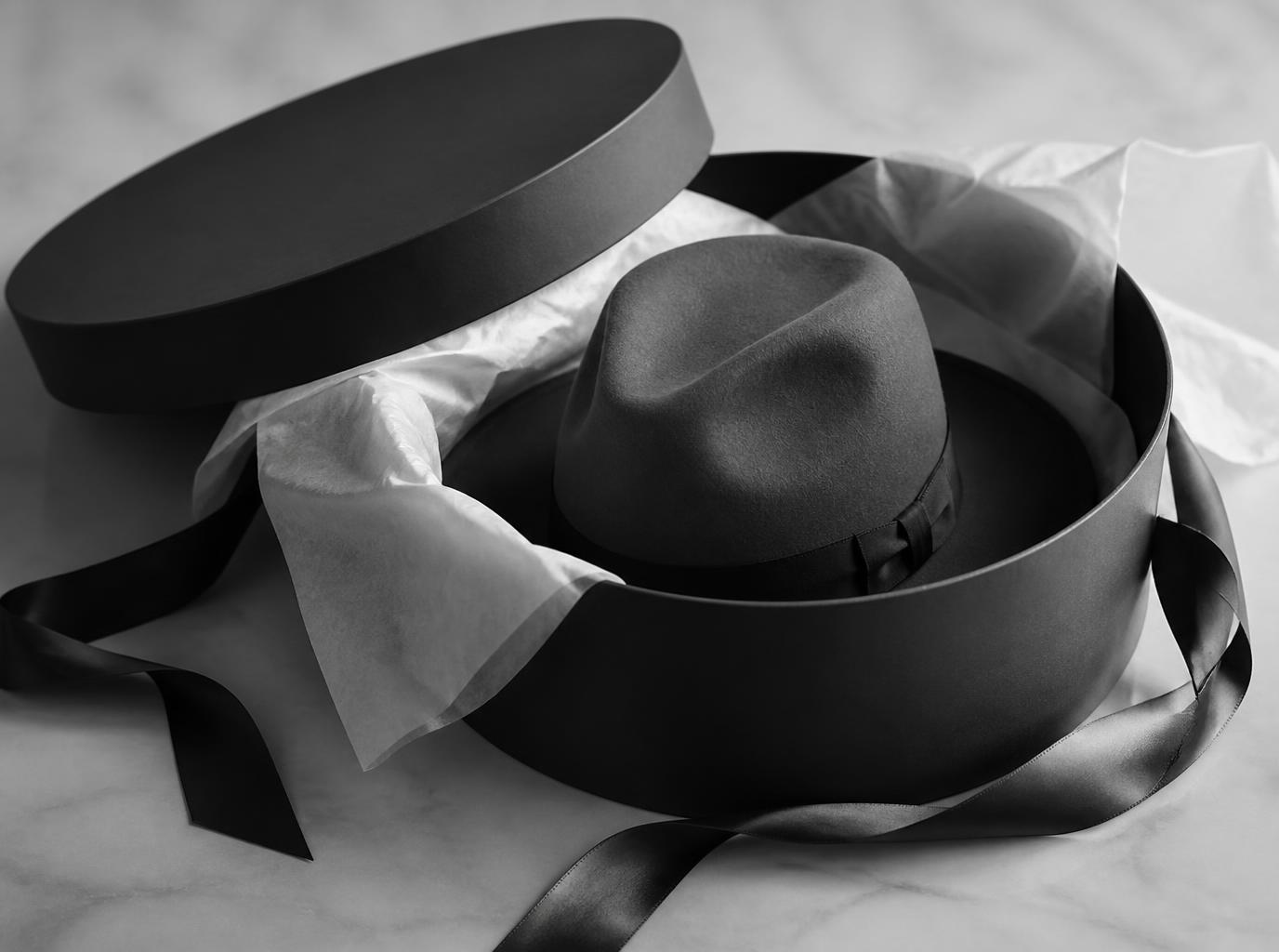 Finished hat tissue-wrapped inside an elegant hat box